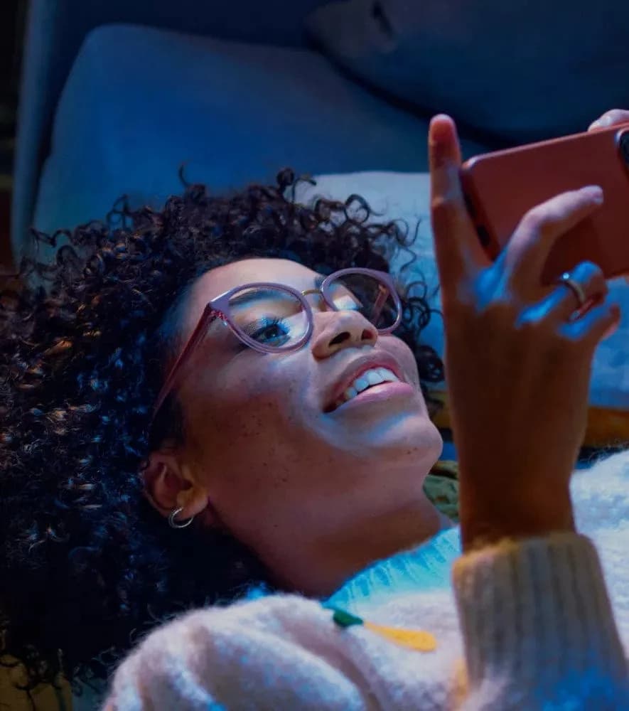 Essilor Eyezen Start Stock Blue UV Capture Lenses, woman looking at her phone while wearing Eyezen Start lenses
