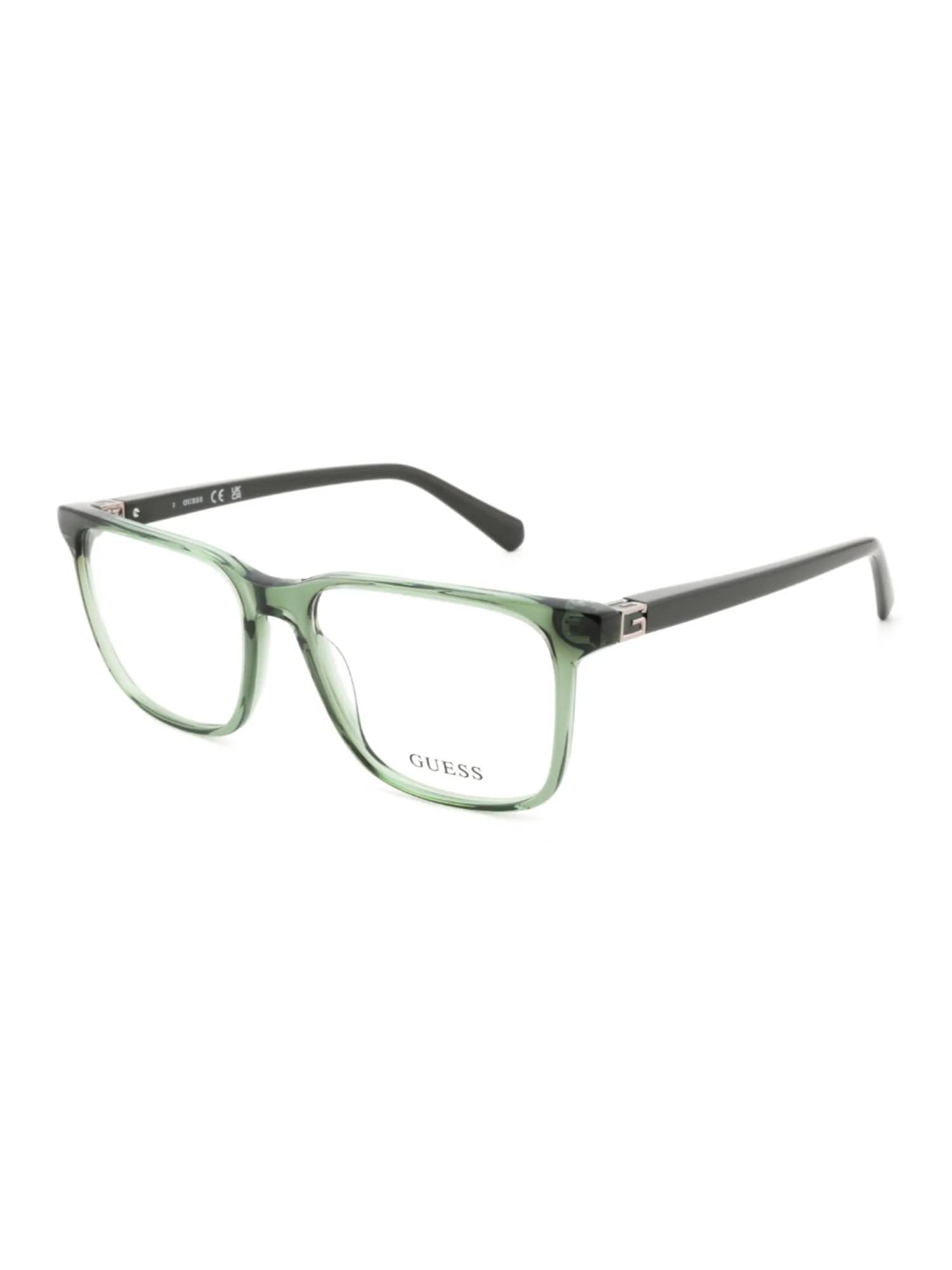 Guess GU50285 square eyeglasses in transparent green (096) with dark green temples, three-quarter view
