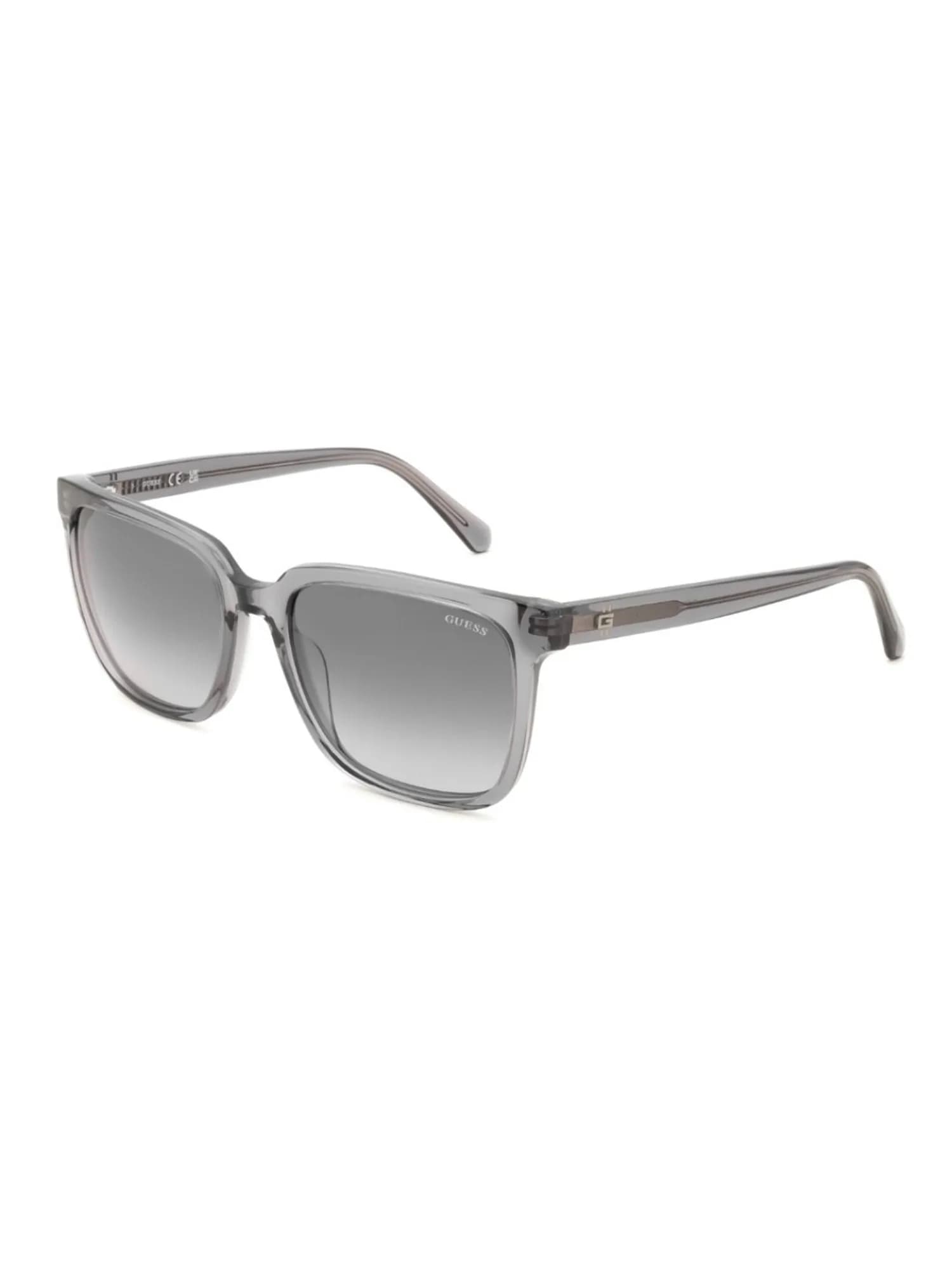 Guess GU00325 square sunglasses in transparent grey (20B) with gradient smoke lenses, three-quarter view