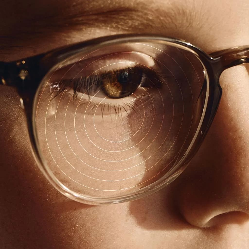 ZEISS MyoCare Single Vision (Rx) Lenses, ZEISS close-up of a MyoCare lens showing the C.A.R.E. ring elements over the wearer's eye